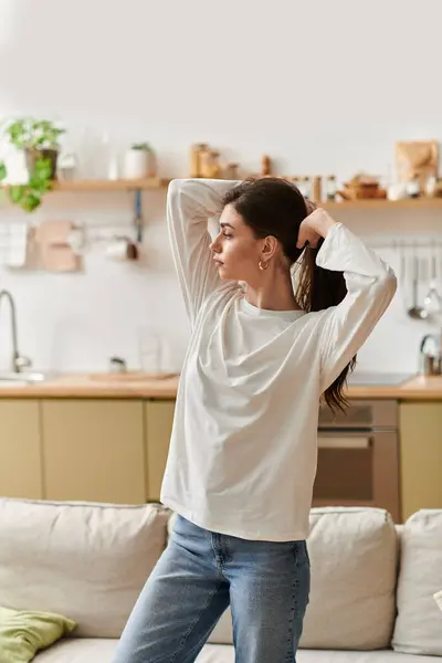 A young woman with brown hair enjoys a peaceful moment while resting in her cozy apartment. — Stock Photo