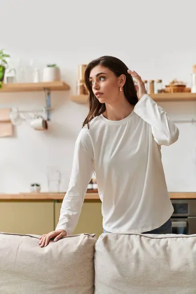 A young woman with brown hair enjoys a serene moment of rest in her cozy apartment. — Stock Photo