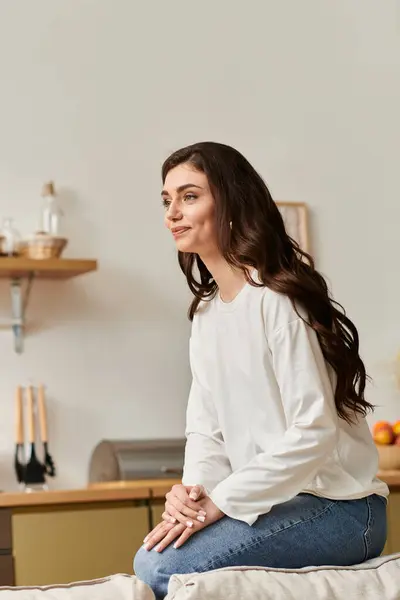 A young woman with brown hair relaxes in casual attire, finding peace at her cozy home. — Stock Photo