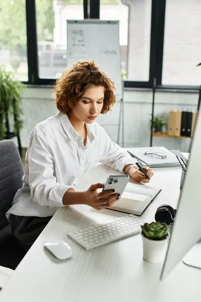 With attention to detail, a young businesswoman manages tasks in her office workspace. — Stock Photo