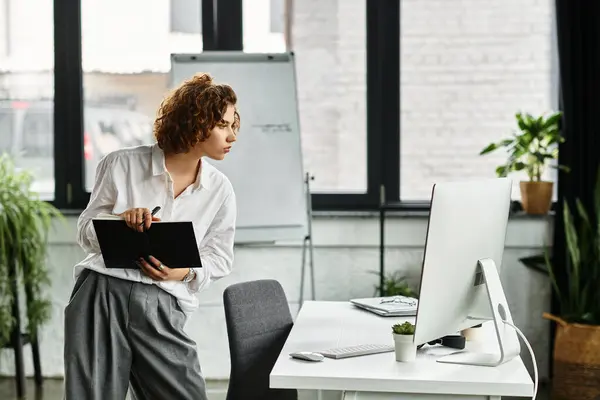 Young businesswoman with curly hair engaged in her tasks at a contemporary office during summer. — Stock Photo