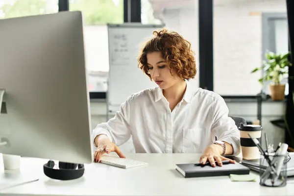 Young business professional focuses intently while managing tasks in a chic office space. — Stock Photo
