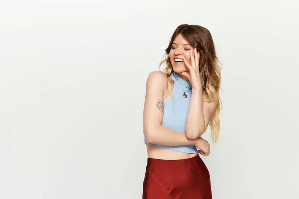 A young beautiful woman radiates happiness while playfully laughing in a stylish summer outfit. — Stock Photo