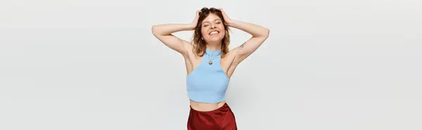 Delighted young woman enjoys the summer ambiance, exuding happiness with her playful pose. — Stock Photo