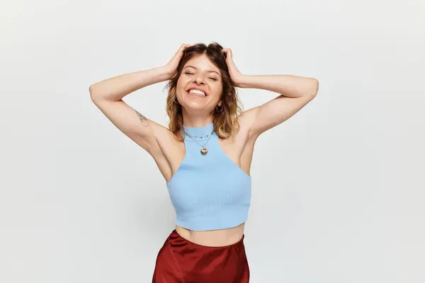 A young, beautiful woman embraces the summer spirit with a joyful smile and playful pose — Stock Photo