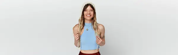 Young woman enjoys a sunny day while wearing a stylish outfit, radiating happiness and joy. — Stock Photo