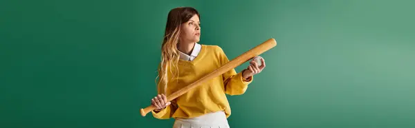 Excited young woman enjoys a summer day, holding a baseball bat and ball, ready to play. — Stock Photo