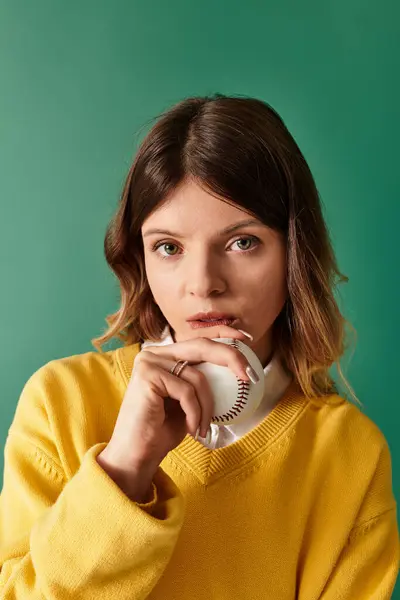 A young woman poses thoughtfully against a bright green background, embodying summer spirit. — Stock Photo