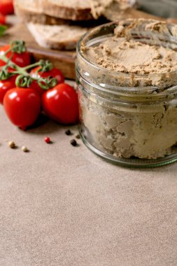 Ev yapımı ciğer ezmesi cam kavanoz ekmek dilimler taze vişneli domates. Gurme aperatif doğal malzemeler. Rustik biçim dokusu arkaplanı.