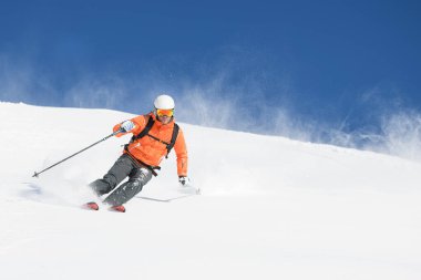 Mountaineering skier during powder descent clipart