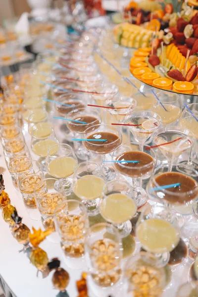 Glasses of champagne on table served for buffet catering party outdoors, close up. High quality photo