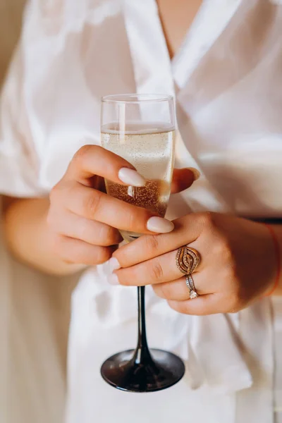 Wedding glasses with champagne in couples hands. High quality photo