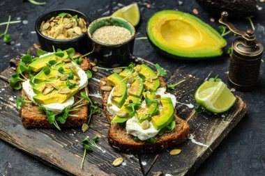 Çavdar ekmekli avokado tostları, lezzetli kahvaltı ya da aperatif, temiz yemek, diyet, vegan gıda konsepti. en üstteki görünüm.