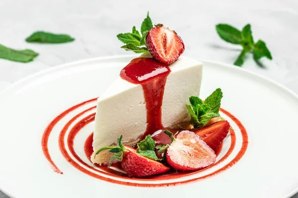 Strawberry Cheesecake with Strawberry Syrup. piece of cheesecake decorated with strawberry sauce on white background.