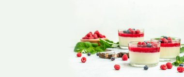 Raspberry sorbet with whipped cream and mint. Italian dessert on a light background in small jars. Long banner format. place for text.