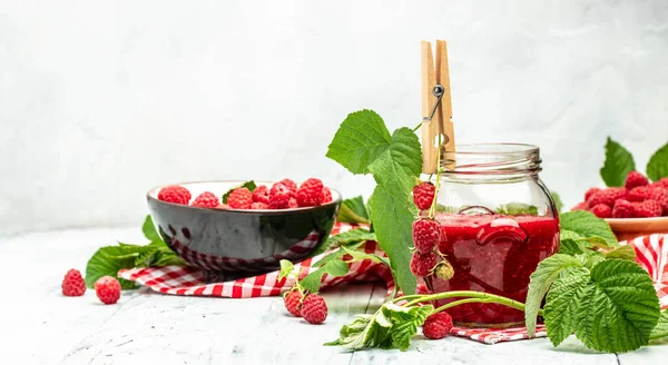 Homemade raspberry jam in jar with raspberries and mint. Long banner format. place for text.