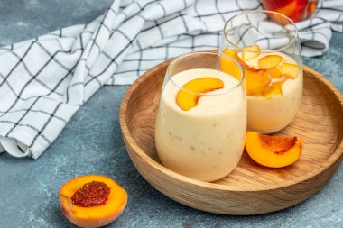 Peach drink in a glass with milk on a light background, Healthy eating. Breakfast, snack, Restaurant menu, dieting, cookbook recipe top view,