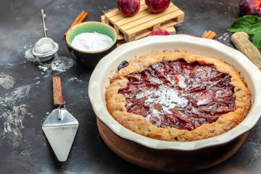 plum cake, powdered sugar is sprinkled on the cake Culinary, cooking, bakery concept. banner, menu, recipe place for text,