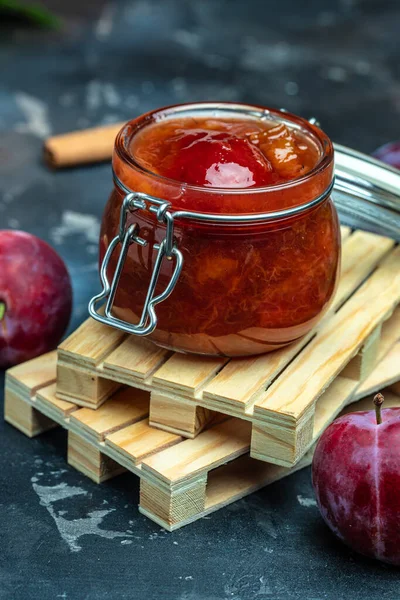 Homemade plum jam and fruits. vertical image. top view. place for text.