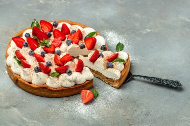 Delicious cake pie tart with fresh strawberries, raspberries, blueberry on white background. banner, menu, recipe place for text, top view.