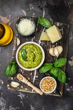 Homemade pesto sauce and ingredients, Traditional Italian pesto recipe for pasta on a dark background, vertical image. top view. place for text,