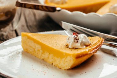 pumpkin pie with whipped cream. Homemade pastry for Thanksgiving traditional Pumpkin Pie. Food recipe background. Close up.