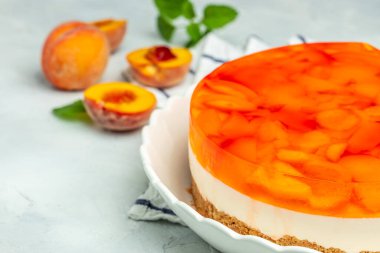 dessert peaches, cheesecake with peache jelly on white plate. Restaurant menu, dieting, cookbook recipe top view.