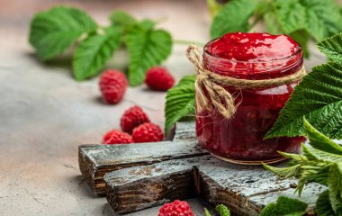 Raspberry jam with berry on light background. Homemade jam with raspberry. banner, menu, recipe place for text, top view.