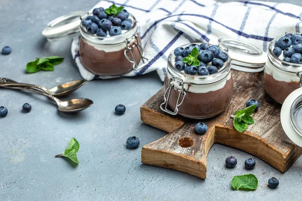 stock image Delicious chocolate mousse or pudding with whipped cream. Chocolate panna cotta with blueberries. Chocolate pudding and greek yogurt parfait.