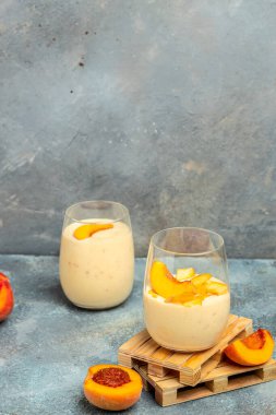 Yogurt with peaches. Summer breakfast drink, fresh blended peach smoothie, vertical image place for text.