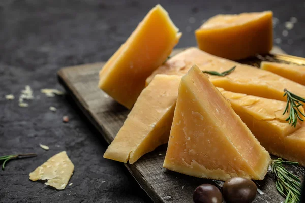 stock image Parmesan cheese on a wooden background. Traditional Italian cheese. place for text, top view.