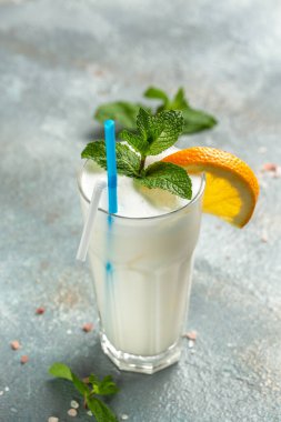 Portakal ve taze nane ile süslenmiş sütlü portakal kokteyli.,