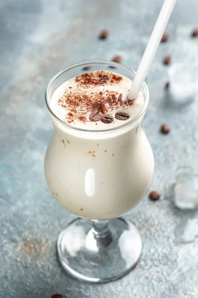 milky coffee cocktail on concrete stone background. vertical image. place for text,