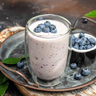 Blueberry jogurt, Homemade berry smoothie. Healthy eating. Diet food yogurt on a light background, banner, menu, recipe place for text, top view,