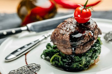 Kırmızı eti ıspanaklı, restoran menüsünde, diyette, yemek kitabı tarifinde göstermek için dilimlenmiş orta pişmiş biftek fileto.,