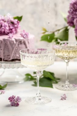 mousse cake blueberry tart. bouquet of purple blooming lilacs, French cuisine, postcard, background.