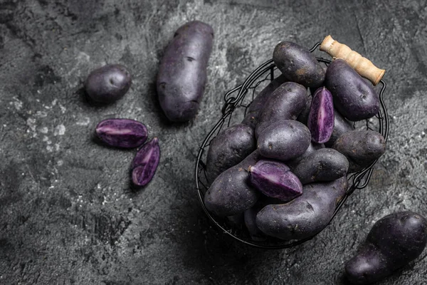 Organic purple sweet potato. Raw sweet potatoes or batatas. pomoea batatas. Batata potato. vegan food ingredient. banner, menu, recipe place for text, top view.