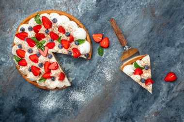 Taze çilekli lezzetli kek turtası, ahududu, gri arka planda yabanmersini. afiş, menü, metin için tarif yeri, üst görünüm.