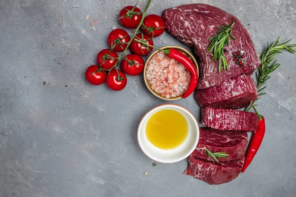 Beef Tenderloin fillet with rosemary and spices. Preparing fresh beef steak ready to cook, Restaurant menu, dieting, cookbook recipe. place for text. top view.