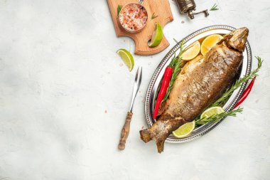 Limonlu ve baharatlı ızgara balık, bir bardak beyaz şarap, akşam yemeği konsepti. Restoran menüsü, diyet, yemek kitabı tarifi..