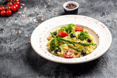 Domates, avokado, siyah zeytin, kırmızı soğan ve peynirli makarna. Restoran menüsü, diyet, yemek kitabı tarifi üst görünümü.