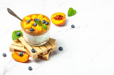 Peach smoothie dessert mousse yogurt with peaches blueberry chia. Eating healthy, vitamin rich Breakfast.