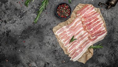 Çiğ domuz pastırması, domuz pastırması ince dilimlenmiş et dilimlenmiş, arka planda domuz yağı, ketojenik diyet, yazı için yer, üst görüş..