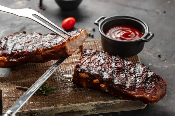 Grilled and smoked ribs with barbeque sauce. Delicious barbecued ribs. Food recipe background. Close up.