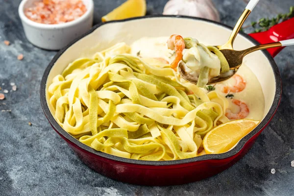Pasta with Shrimp and bechamel sauce in a pan. Food recipe background. Close up.
