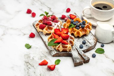 belgian waffles. Berry Belgian Waffle with raspberries, strawberries and blueberries. Delicious breakfast or snack.