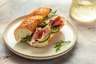 Delicious appetiser Italian prosciutto and Spanish Iberian ham snack. Delicious breakfast or snack, top view.