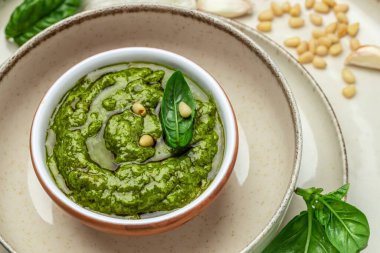 green pesto with basil, pine nuts, parmesan cheese. Food recipe background. Close up,