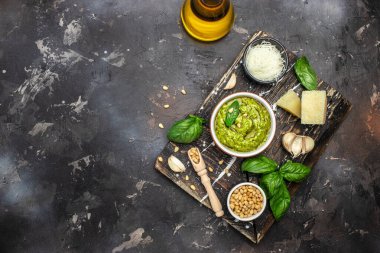 Italian basil pesto sauce bowl with green pesto pine nuts, parmesan and garlic. top view.