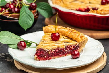 Delicious Homemade Cherry Pie, Flaky Crust, piece on a plate and the whole homemade cherry pie, top view,